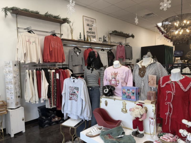 Flat lay of cute but comfy jeans and sweatshirt from Hallie and Company boutique