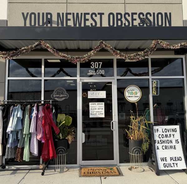 Try on room area at Hallie and Company with cozy lighting and clothing ready to style