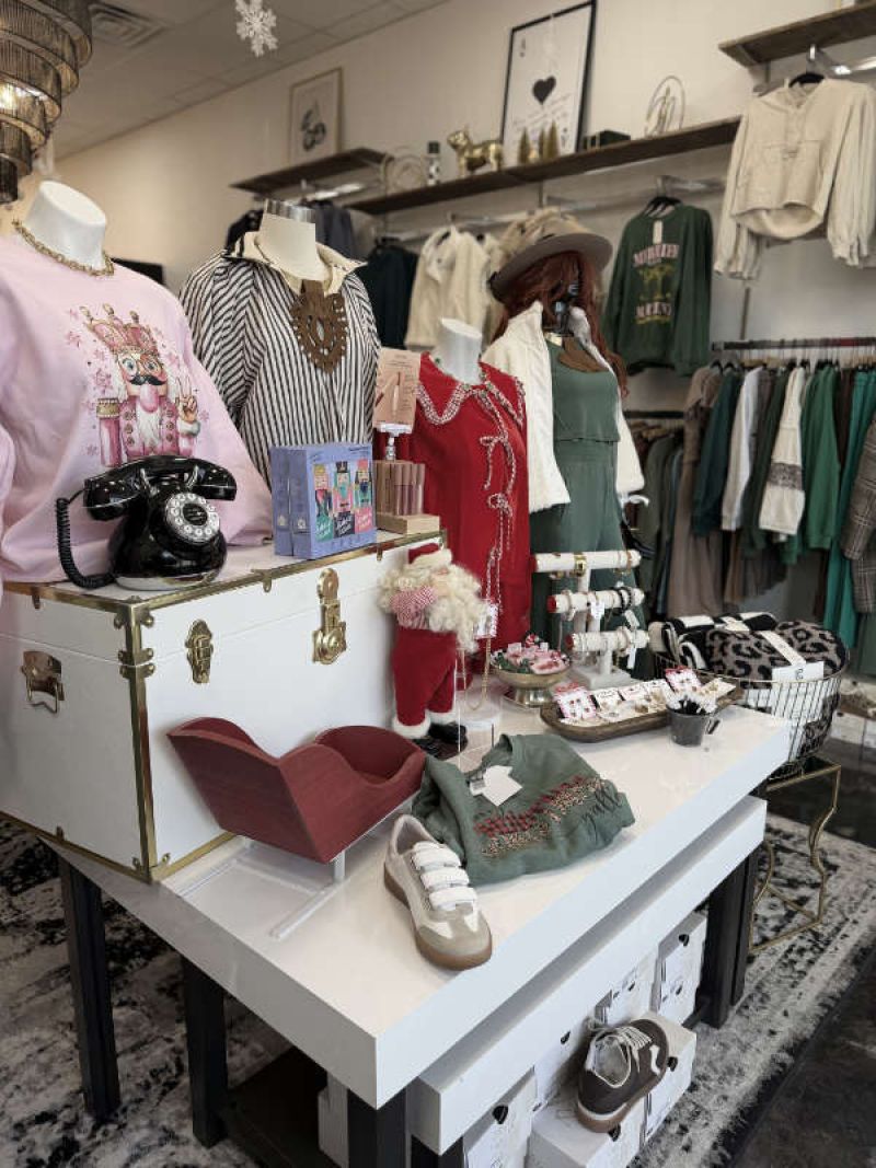 Two friends laughing and shopping for cute but comfy outfits at Hallie and Company